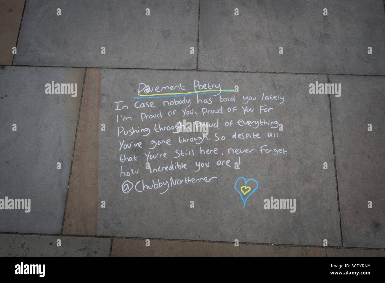 Pavement poetry on the streets of Manchester by the Chubbynortherner. Stock Photo