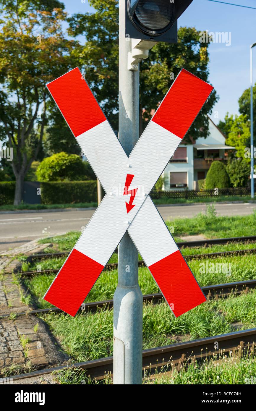 Railway crossing sign - crossbuck - with electricity hazard warning at ...