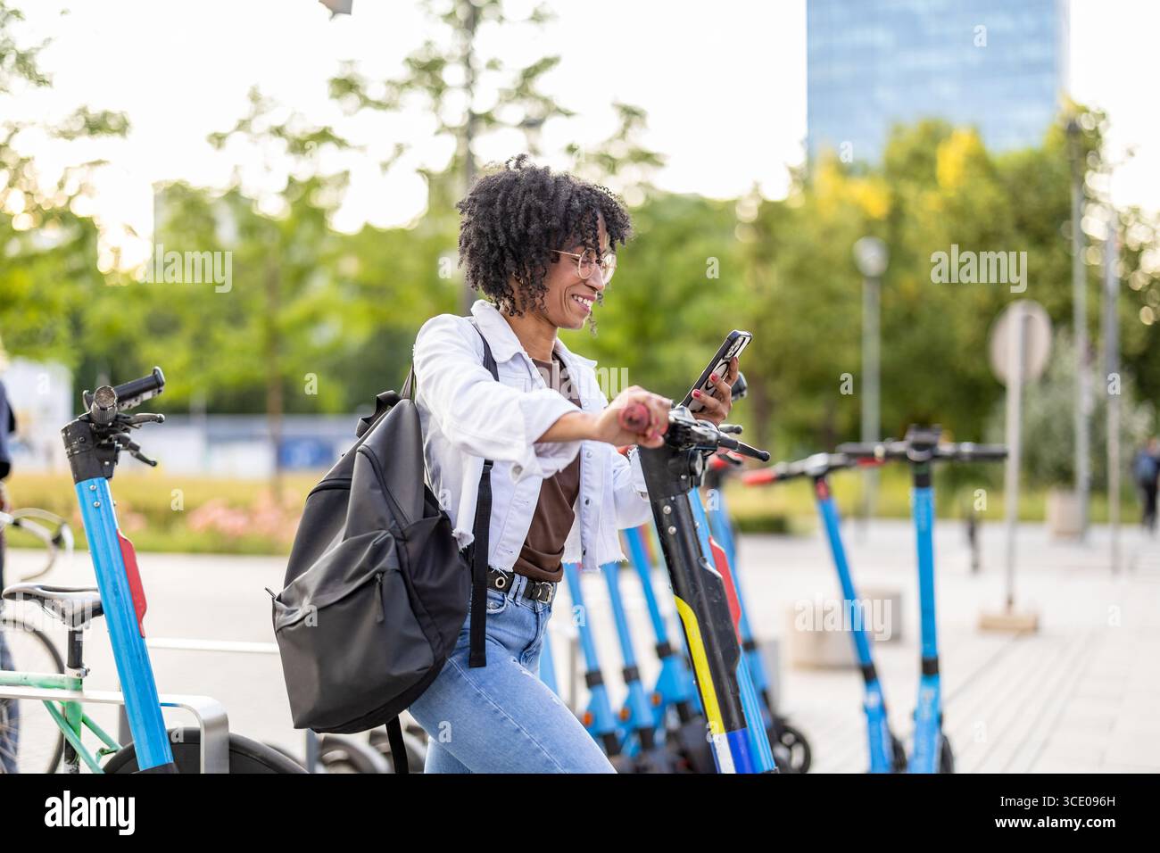 Woman activating electric scooter from smart phone Stock Photo