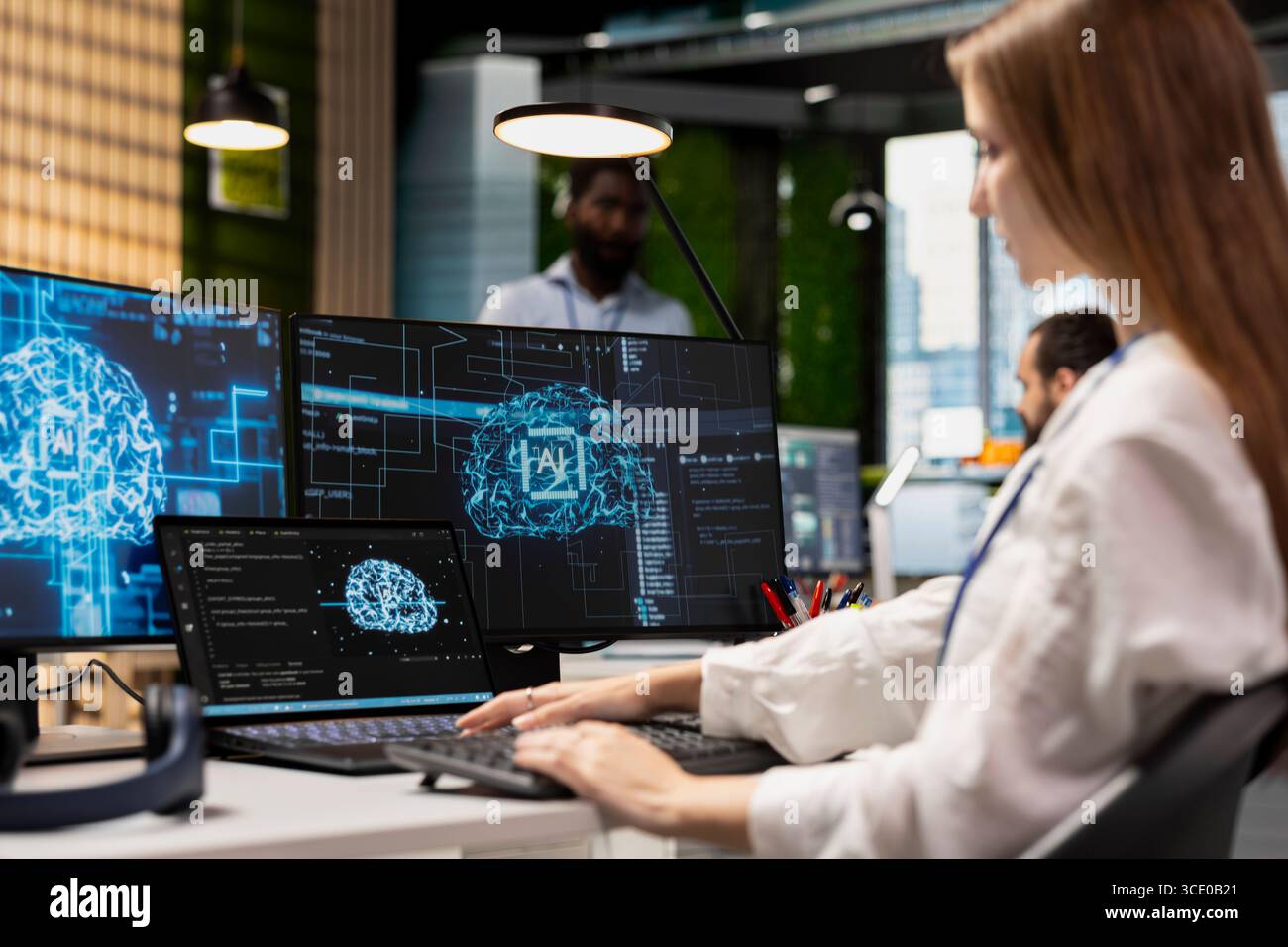 Female engineer developing applications using AI LLM chatbot on multiple devices. Worker doing internship in tech startup relying on artificial intelligence assistant to debug applications Stock Photo