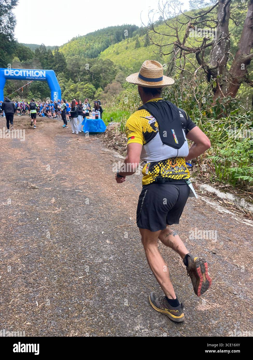 A runner from the Ultra Trail segment of Trail Run Real Priolo enters the final 10 km, shared with the Mini Trail course, in the Azores, Portugal. - Smartphone Captured Stock Image