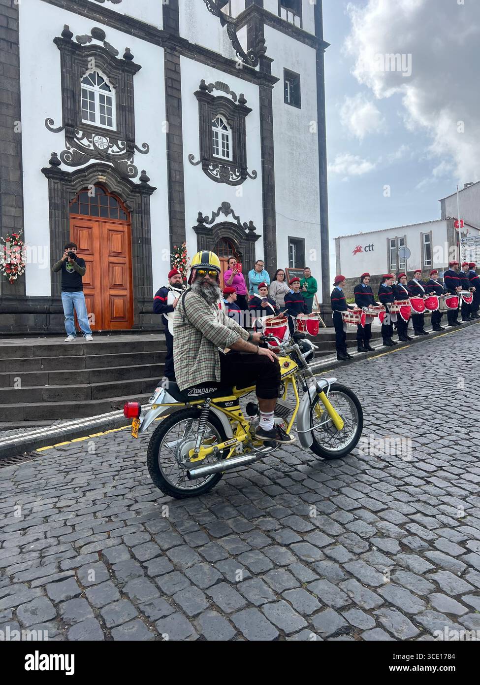 José do Anzol, on his Zündapp motorcycle, opens the non-competitive walk at the Trail Run Real Priolo event in Nordeste, Azores. - Smartphone Captured Stock Image