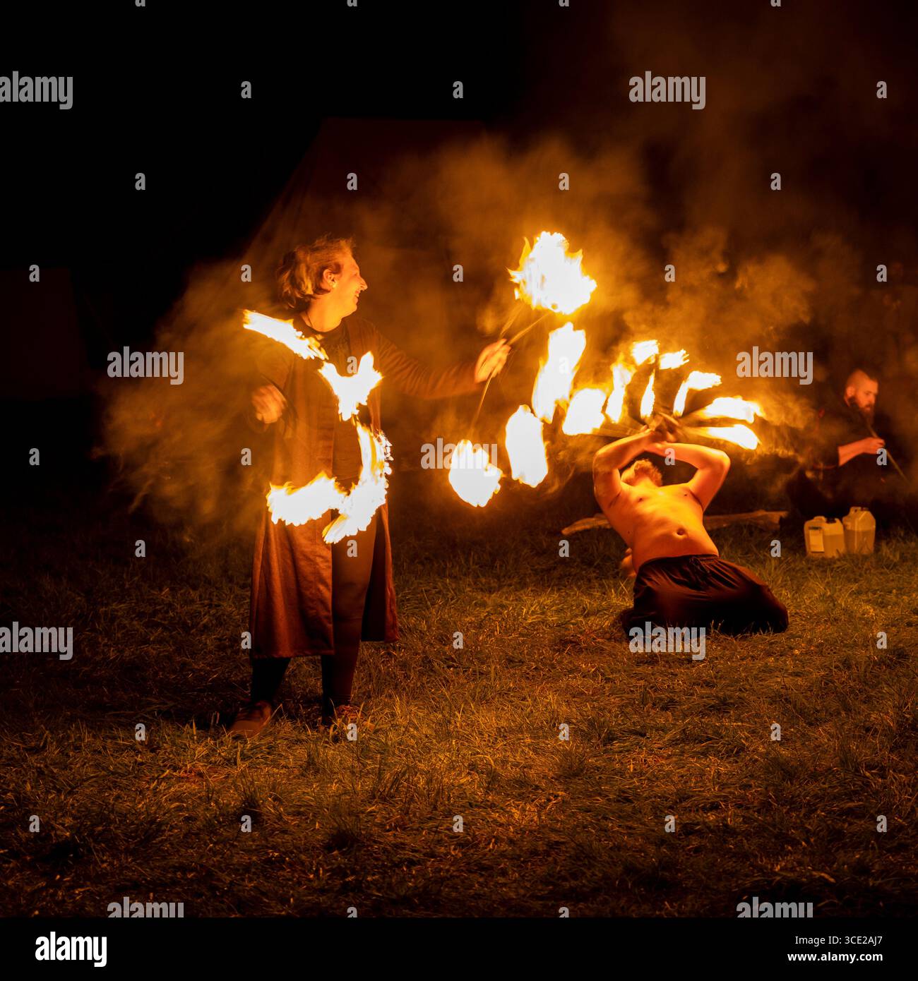 Fire artists at night in a spectacular show Stock Photo - Alamy
