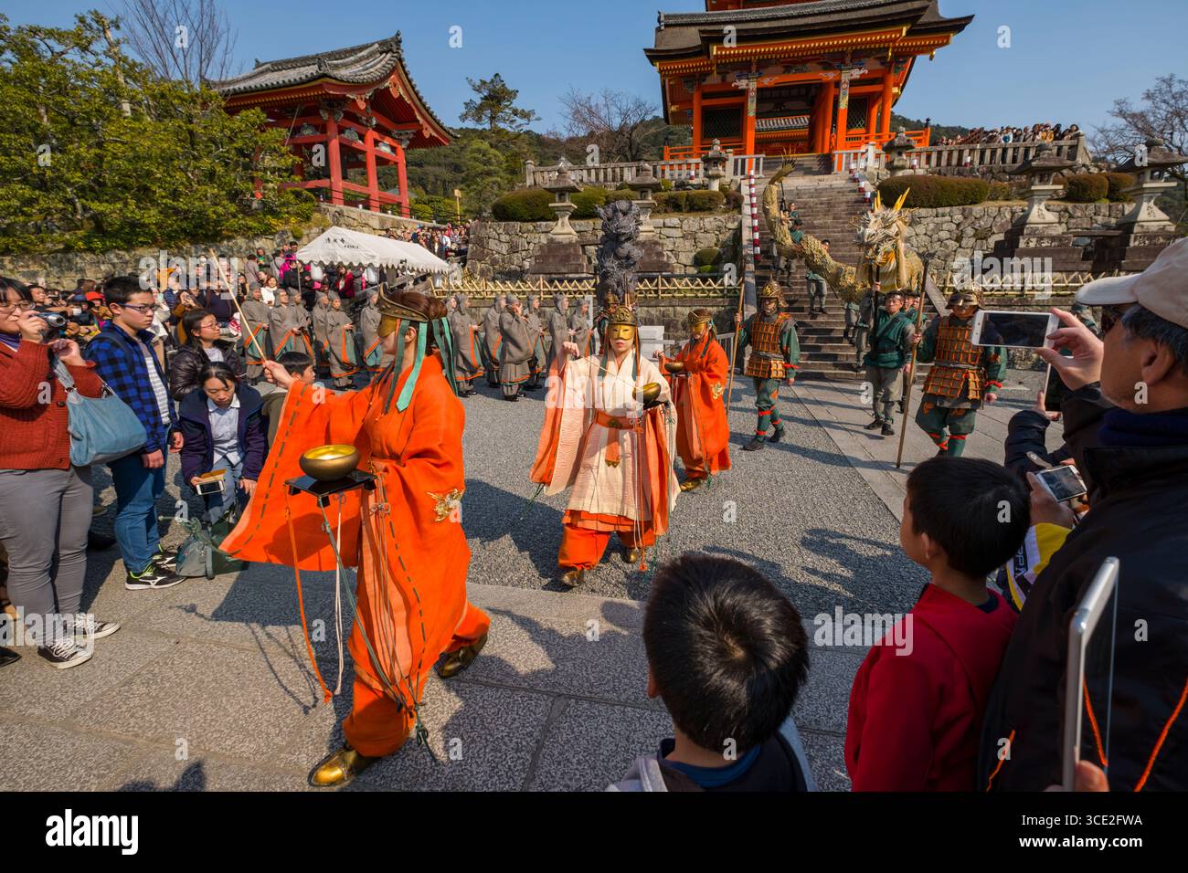 Procession of male and female performers dressed in robes during the ...