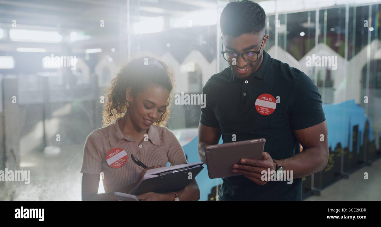 Animal shelter, people and paperwork with tablet for pet records, adoption info and volunteering. Flare, happy volunteers or digital tech at rescue Stock Photo