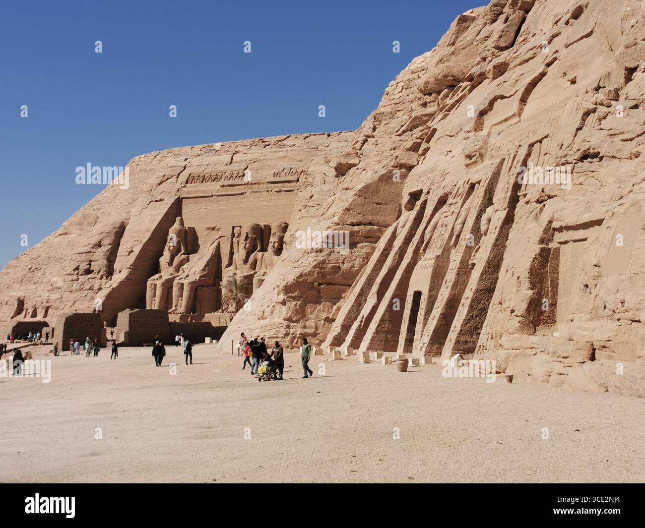 Temples of Ramses II and Nefertari, Abu Simbel, Egypt. Ancient rock-cut monuments, UNESCO site, iconic pharaonic statues, desert landmark near Aswan. - Smartphone Captured Stock Image