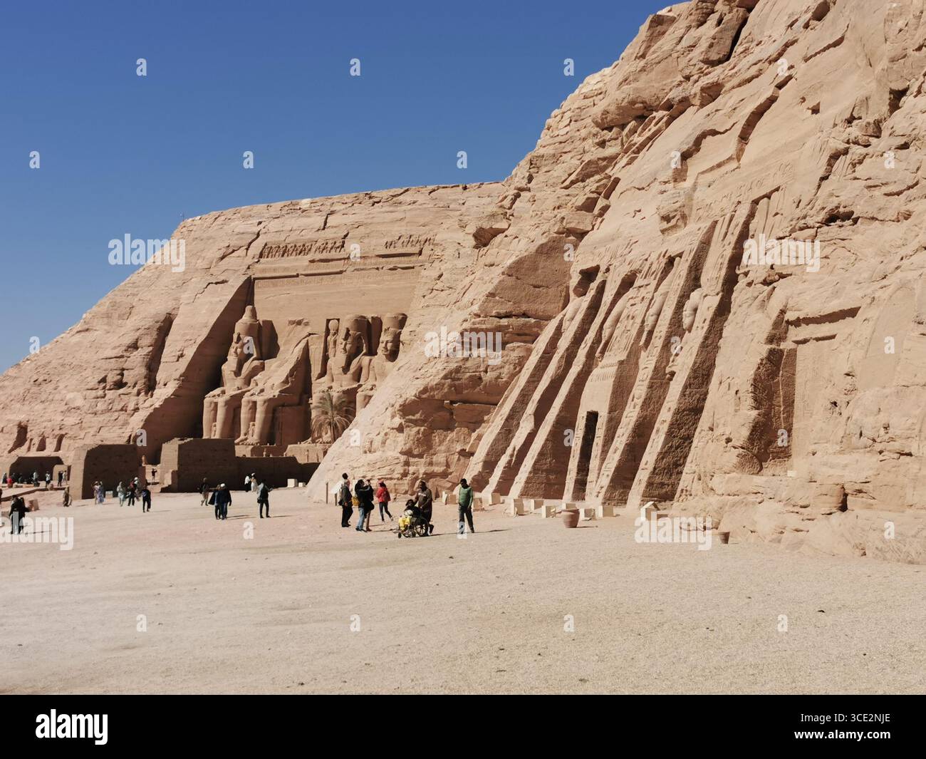 Temples of Ramses II and Nefertari, Abu Simbel, Egypt. Ancient rock-cut monuments, UNESCO site, iconic pharaonic statues, desert landmark near Aswan. - Smartphone Captured Stock Image