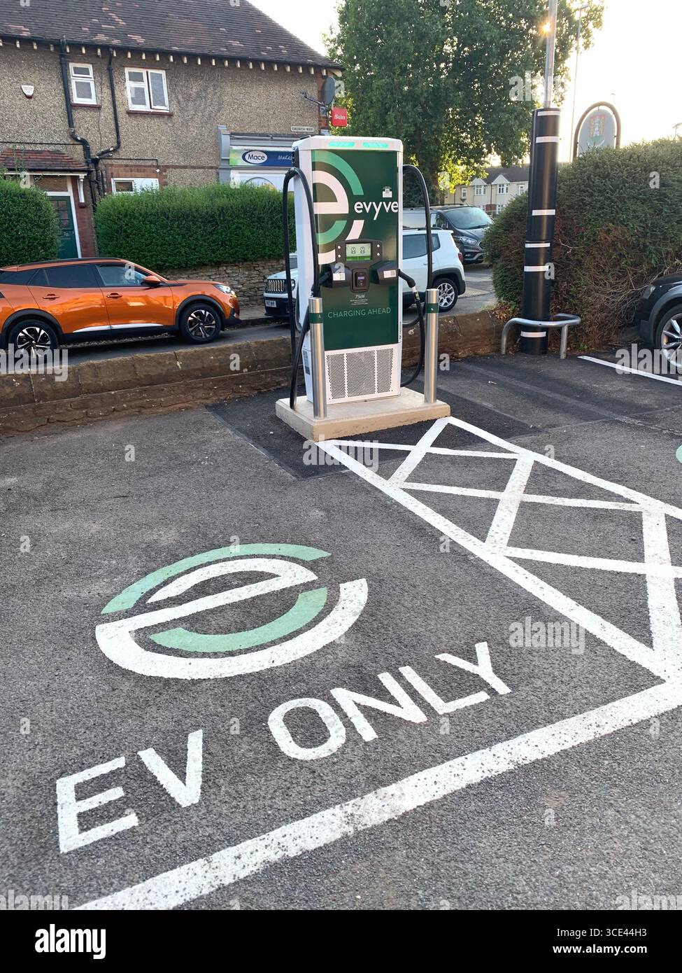 Trumpet Pub Northampton England British Electric vehicle point charger charging outside marked only place cables cable wire markings ground white UK - Smartphone Captured Stock Image