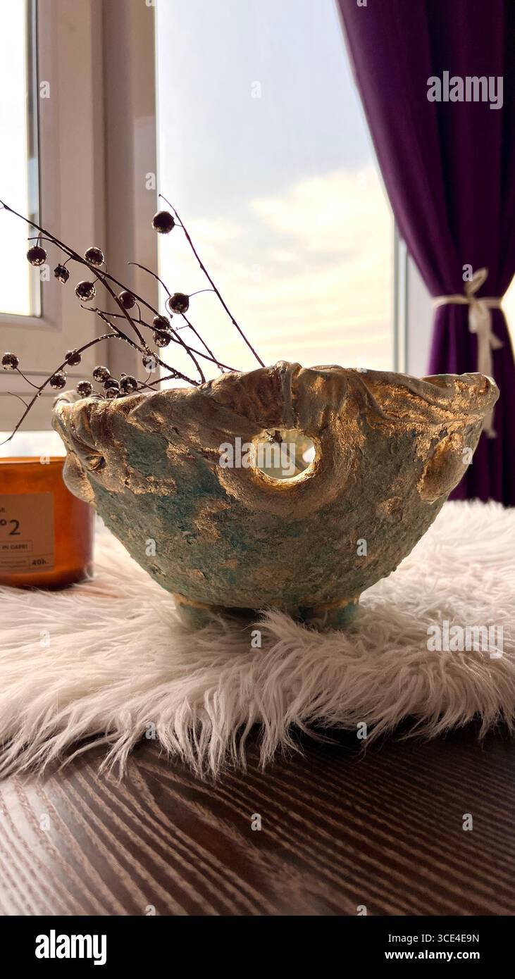 A decorative papier-mâché bowl, pale blue with gold trim - Smartphone Captured Stock Image