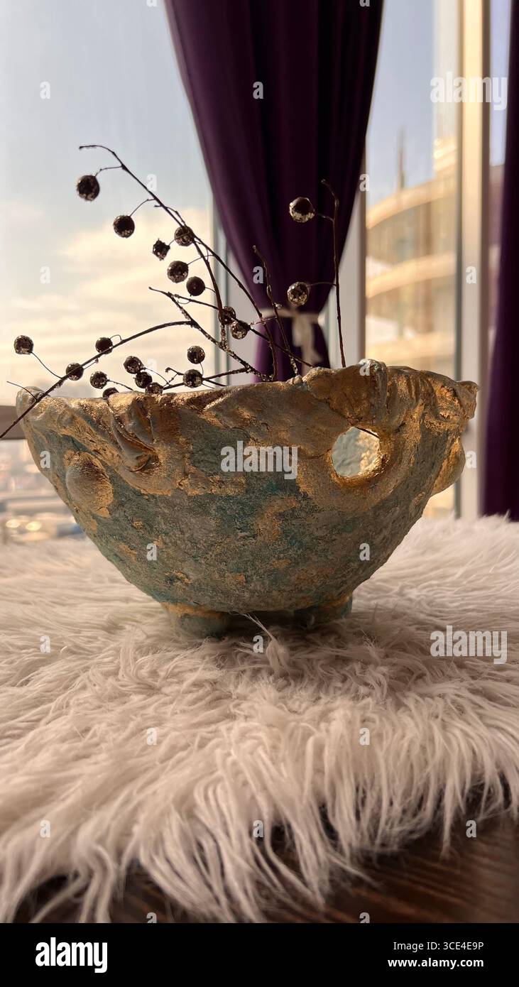 A decorative papier-mâché bowl, pale blue with gold trim - Smartphone Captured Stock Image