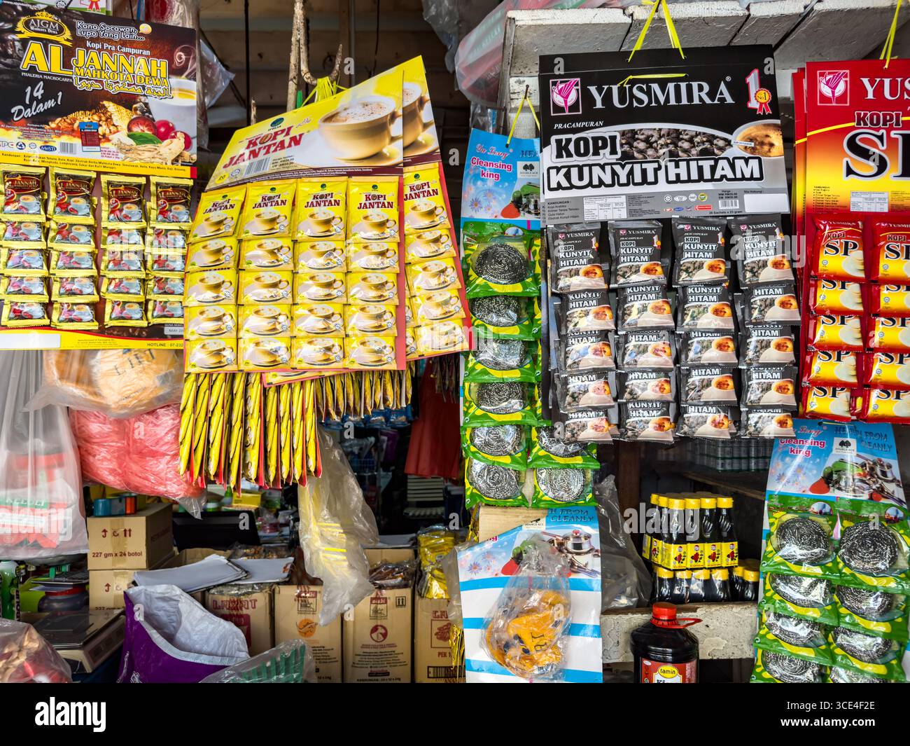 A colorful display of various packaged food and kopi coffee drink products in a local market stall, showcasing teas and drink pre mixes. - Smartphone Captured Stock Image