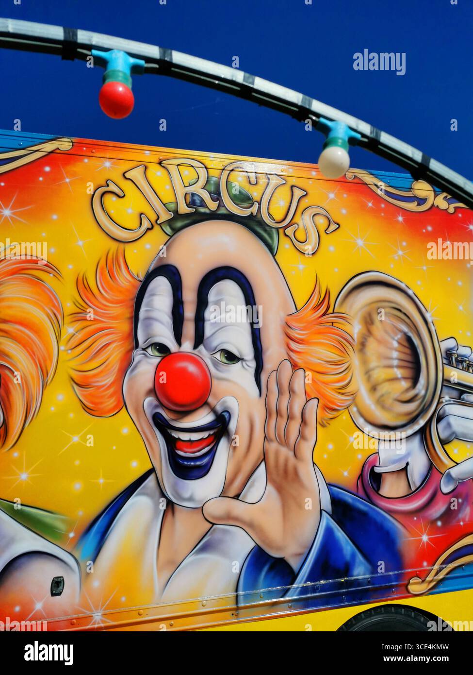 Colorful circus clowns painted on a vibrant backdrop celebrating fun and joy in an entertainment setting. France - Smartphone Captured Stock Image