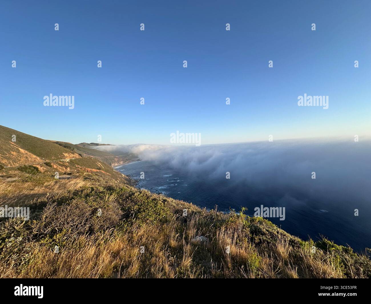Scenic view of the Pacific Ocean and rugged cliffs along the Big Sur coastline with fog drifting inland, California, USA. A dramatic natural landscape - Smartphone Captured Stock Image