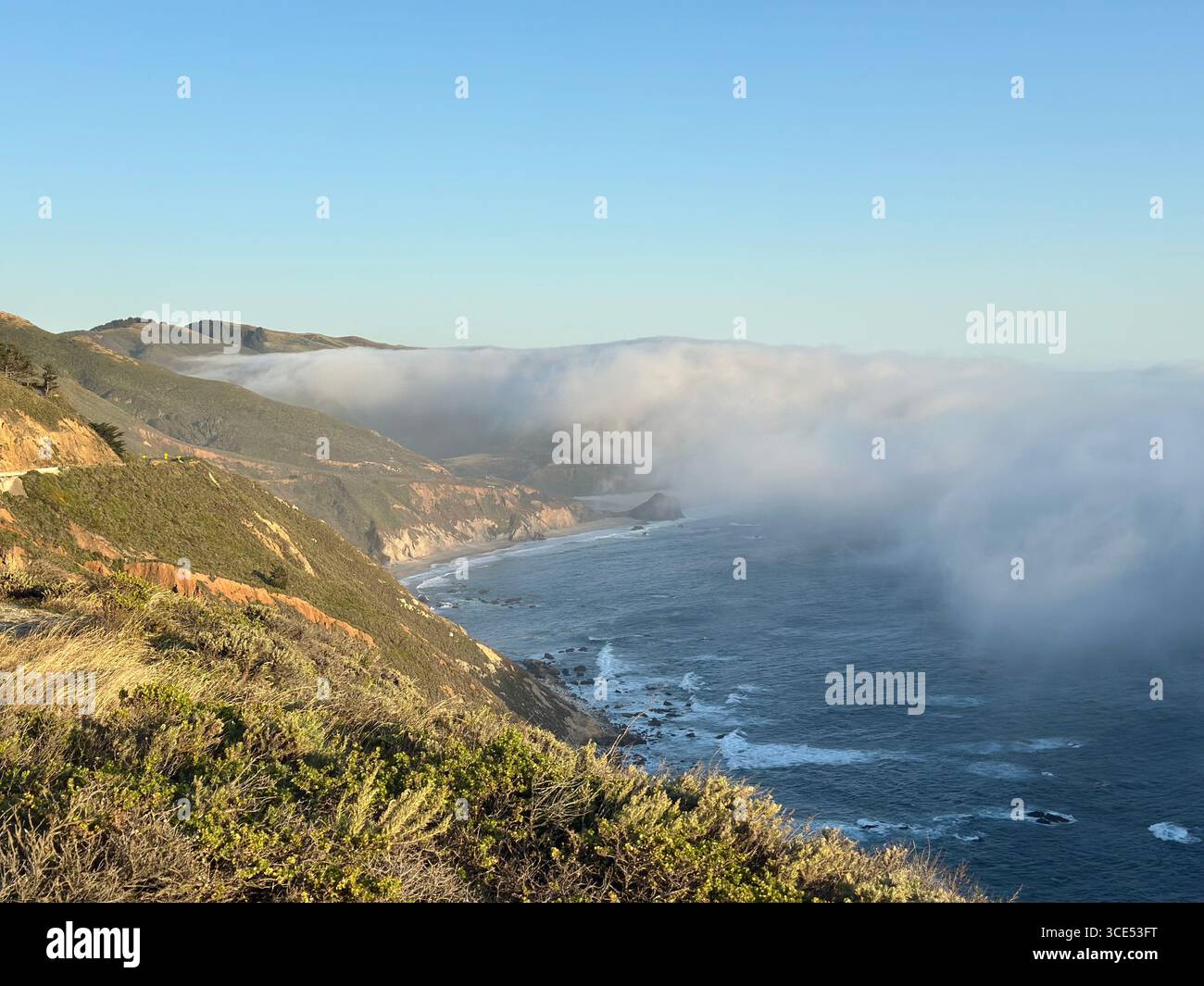 Scenic view of the Pacific Ocean and rugged cliffs along the Big Sur coastline with fog drifting inland, California, USA. A dramatic natural landscape - Smartphone Captured Stock Image