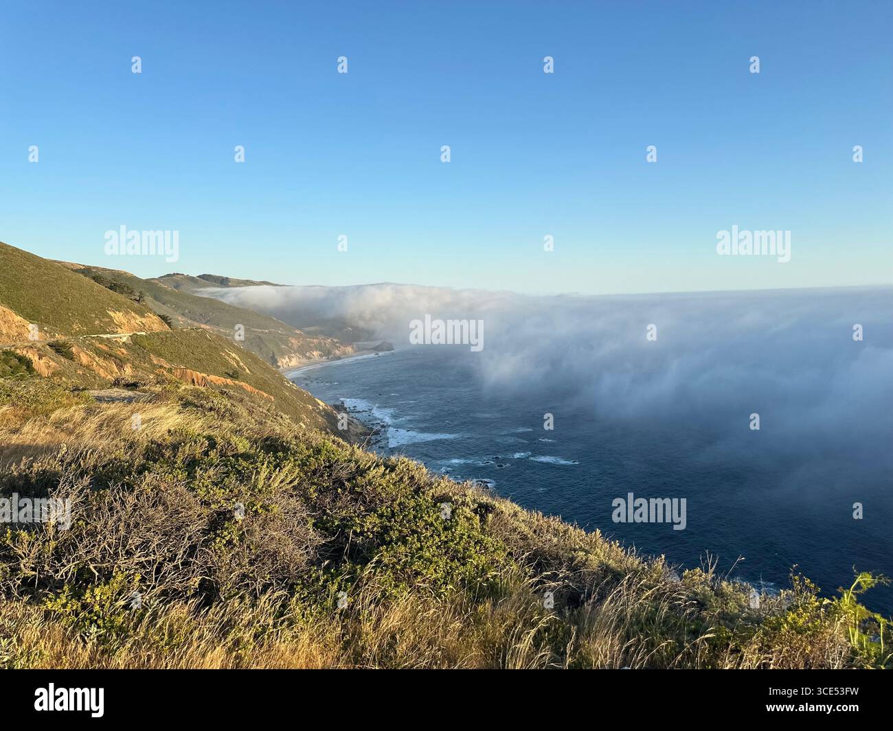 Scenic view of the Pacific Ocean and rugged cliffs along the Big Sur coastline with fog drifting inland, California, USA. A dramatic natural landscape - Smartphone Captured Stock Image