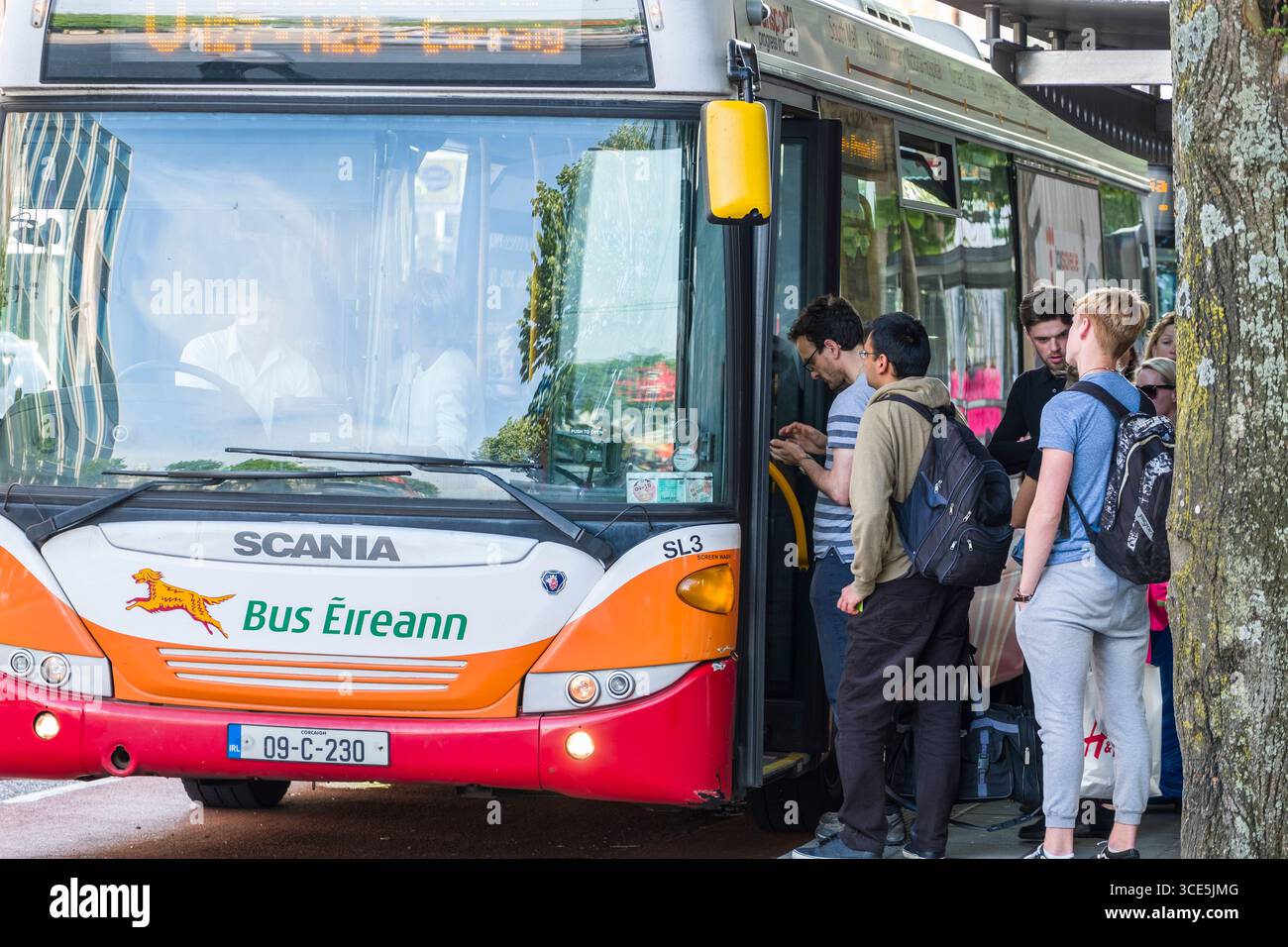 Group of people waiting to board Bus Eireann bus, South Mall Street, Centre, Cork, County Cork, Munster, Ireland Stock Photo