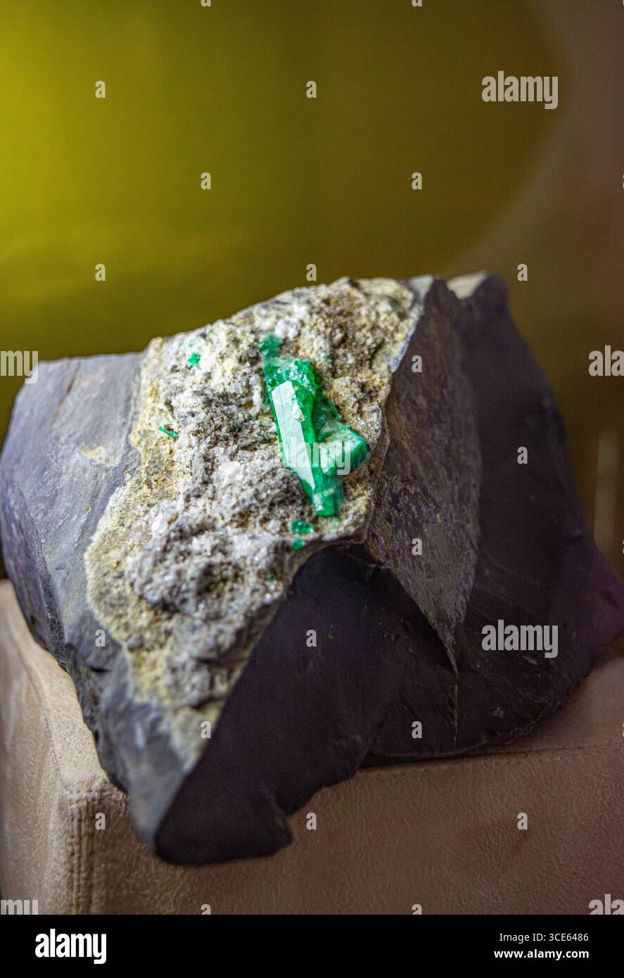 A close-up of a Colombian emerald crystal embedded in rock, showcasing ...