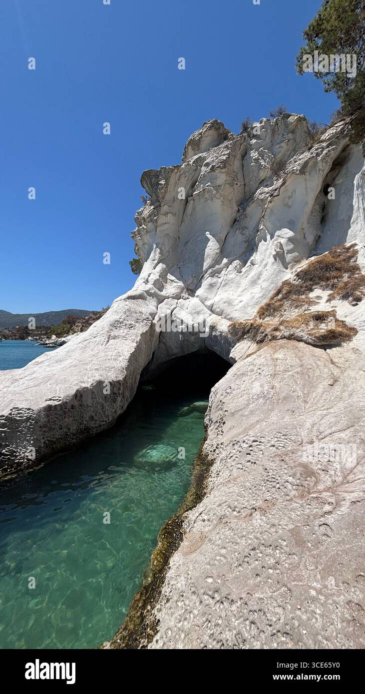 Manal Cave, İzmir, Turkey – dramatic white cliffs and turquoise sea, a natural hidden cove ideal for tourism, travel and landscape photography. - Smartphone Captured Stock Image