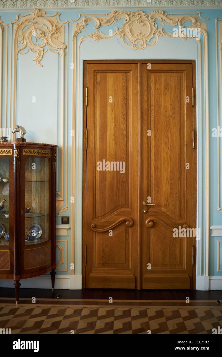 Ornate wooden double doors featuring intricate carved details standing ...