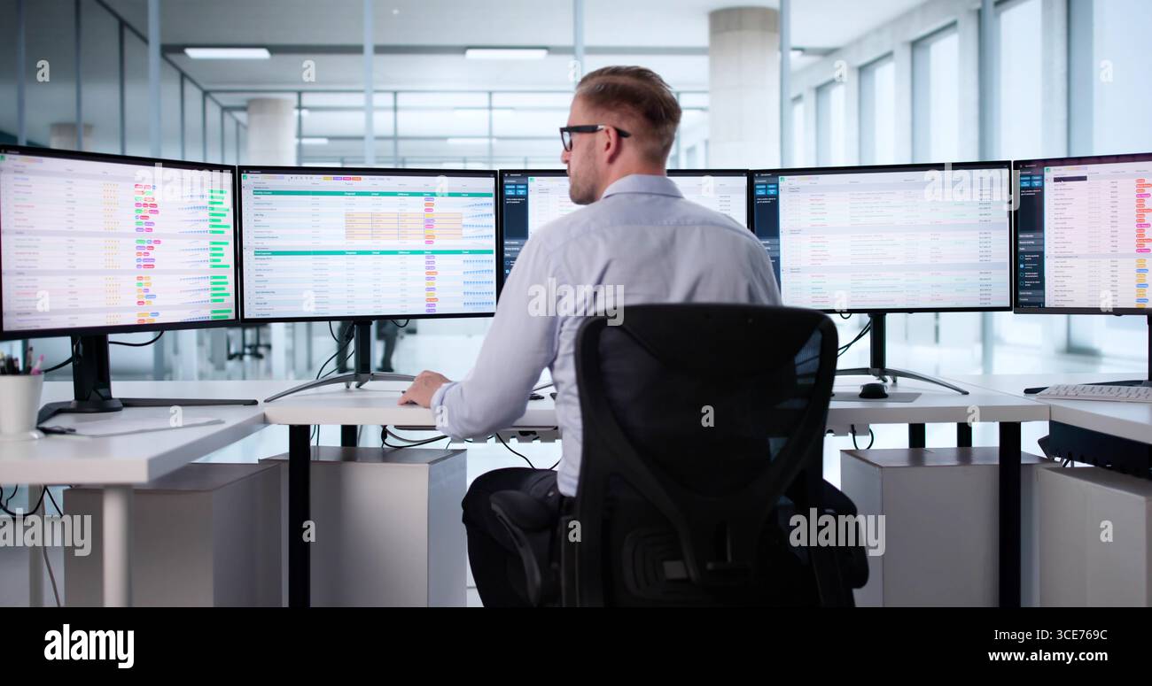 Medical Data Coding: Man Analyzing Patient Billing With Spreadsheet Software. Stock Photo
