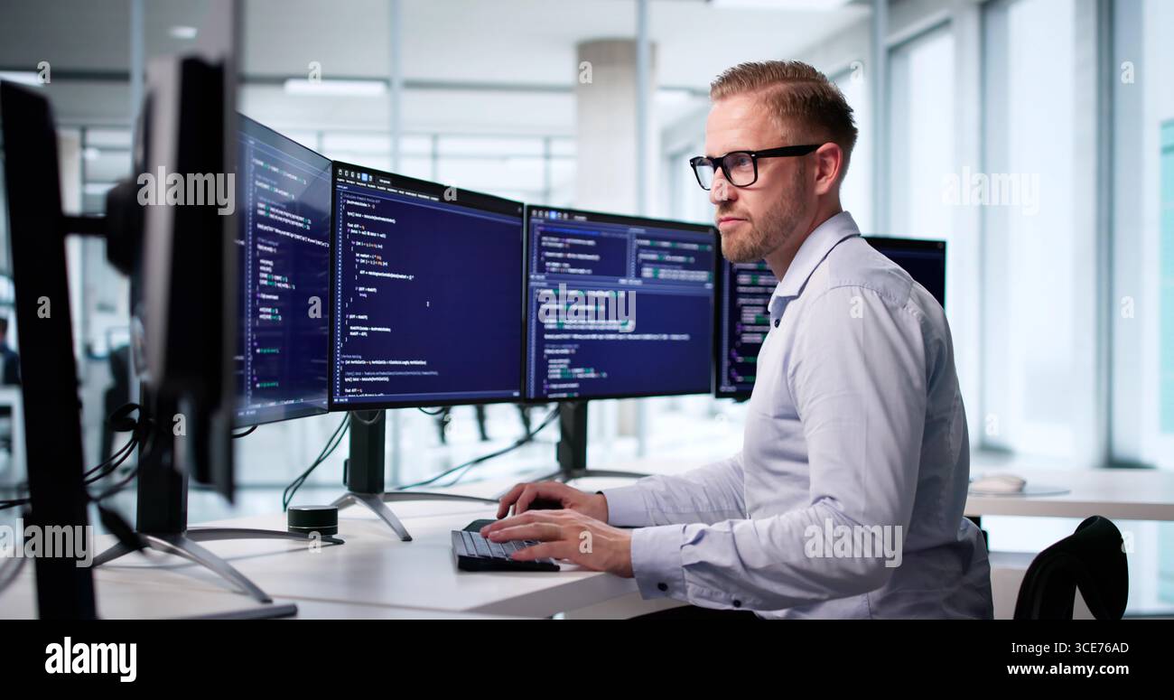 Male Software Engineer Coding At Office Computer Screen For Development. Stock Photo