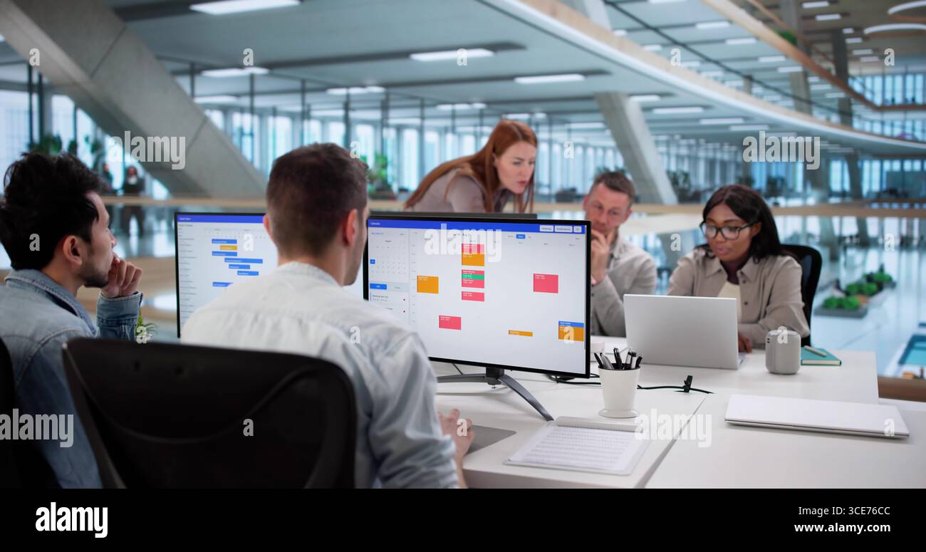 Multiracial Team Using Kanban Board For Agile Software Development Stock Photo