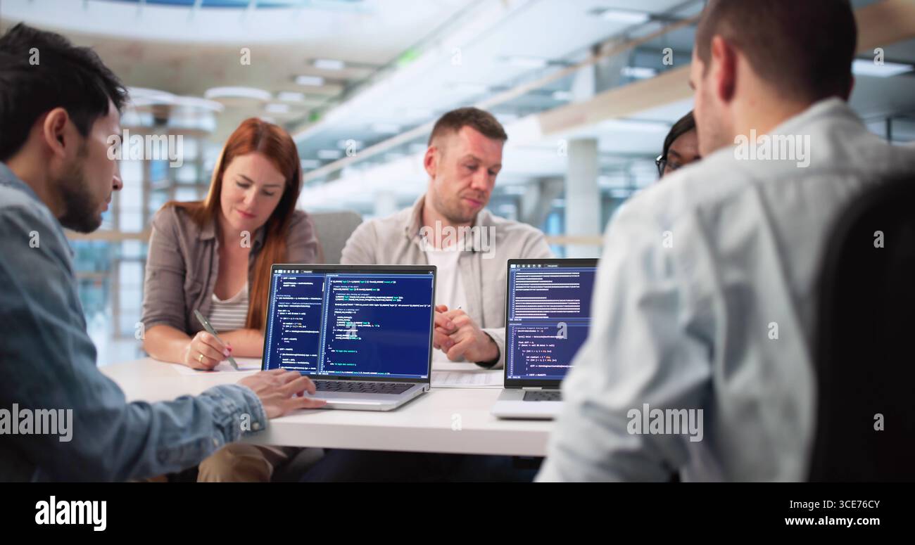 Multiracial Software Engineers Collaborate On Coding Project For Tech Company Stock Photo