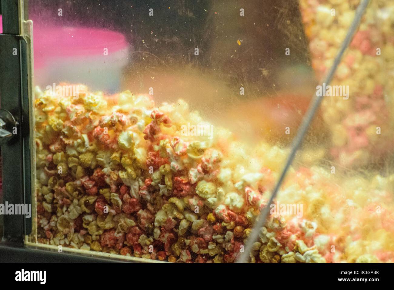 A close up of colorful popcorn in a glass popcorn machine. Stock Photo