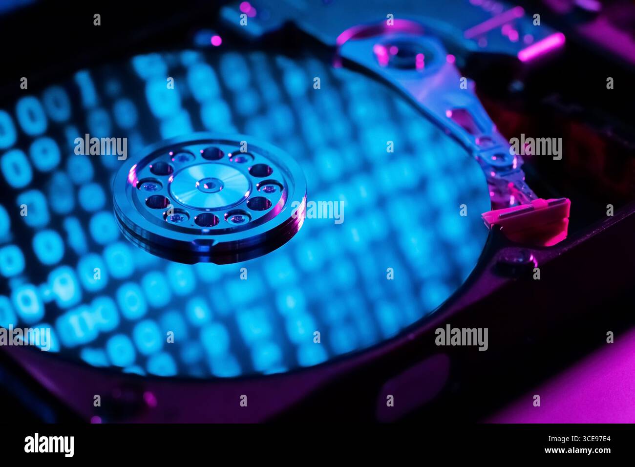 A close-up of a hard disk with an abstract reflection of the binary code Stock Photo