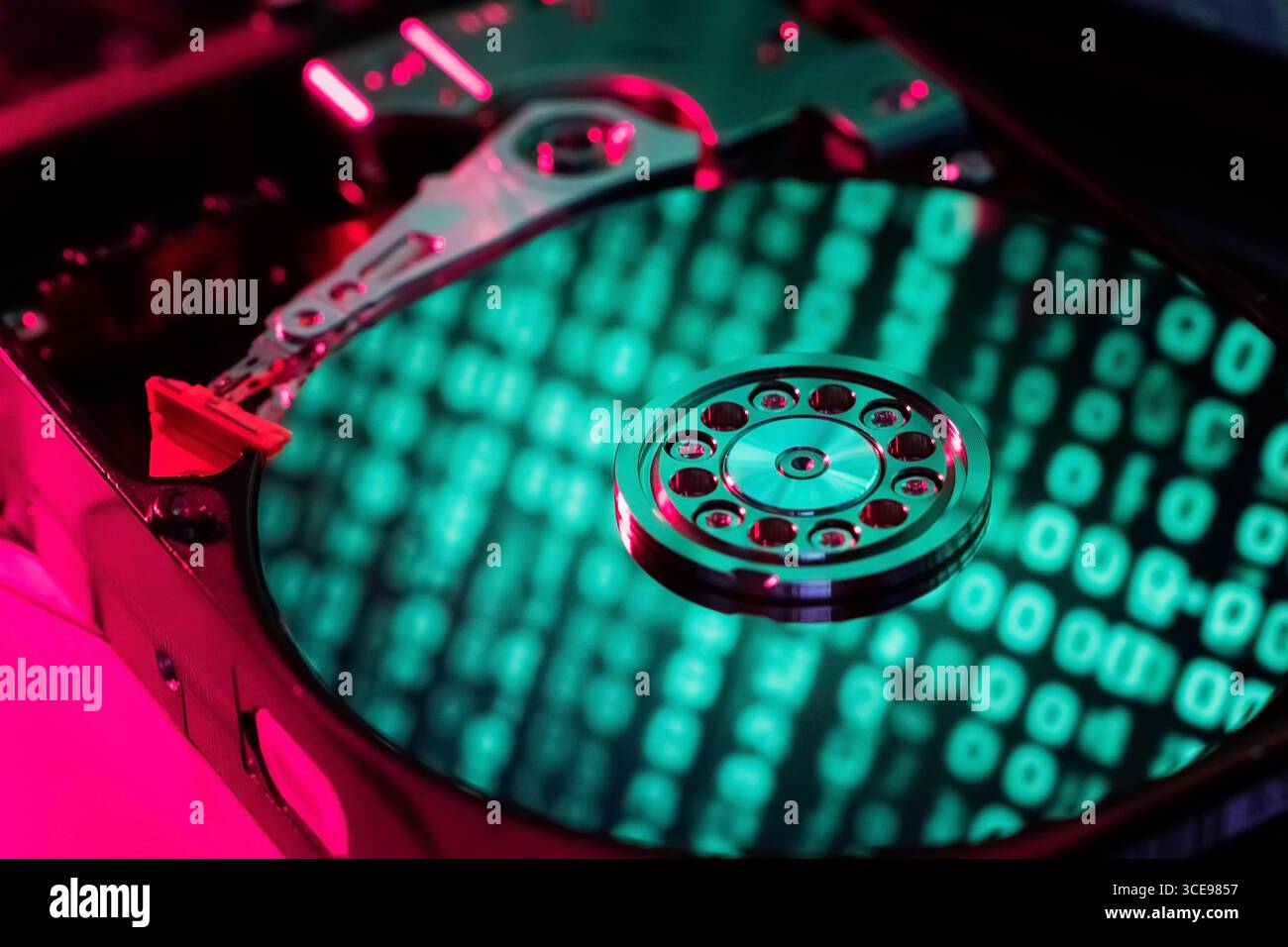 The computer code is displayed in green numbers on the open hard disk Stock Photo