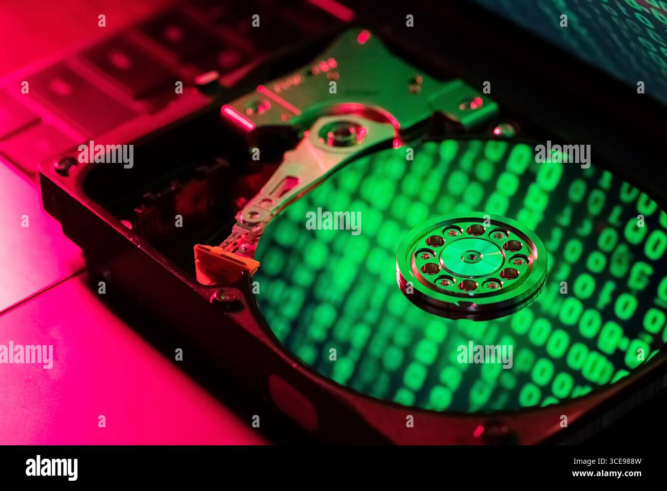 The computer code is displayed in green numbers on the open hard disk Stock Photo