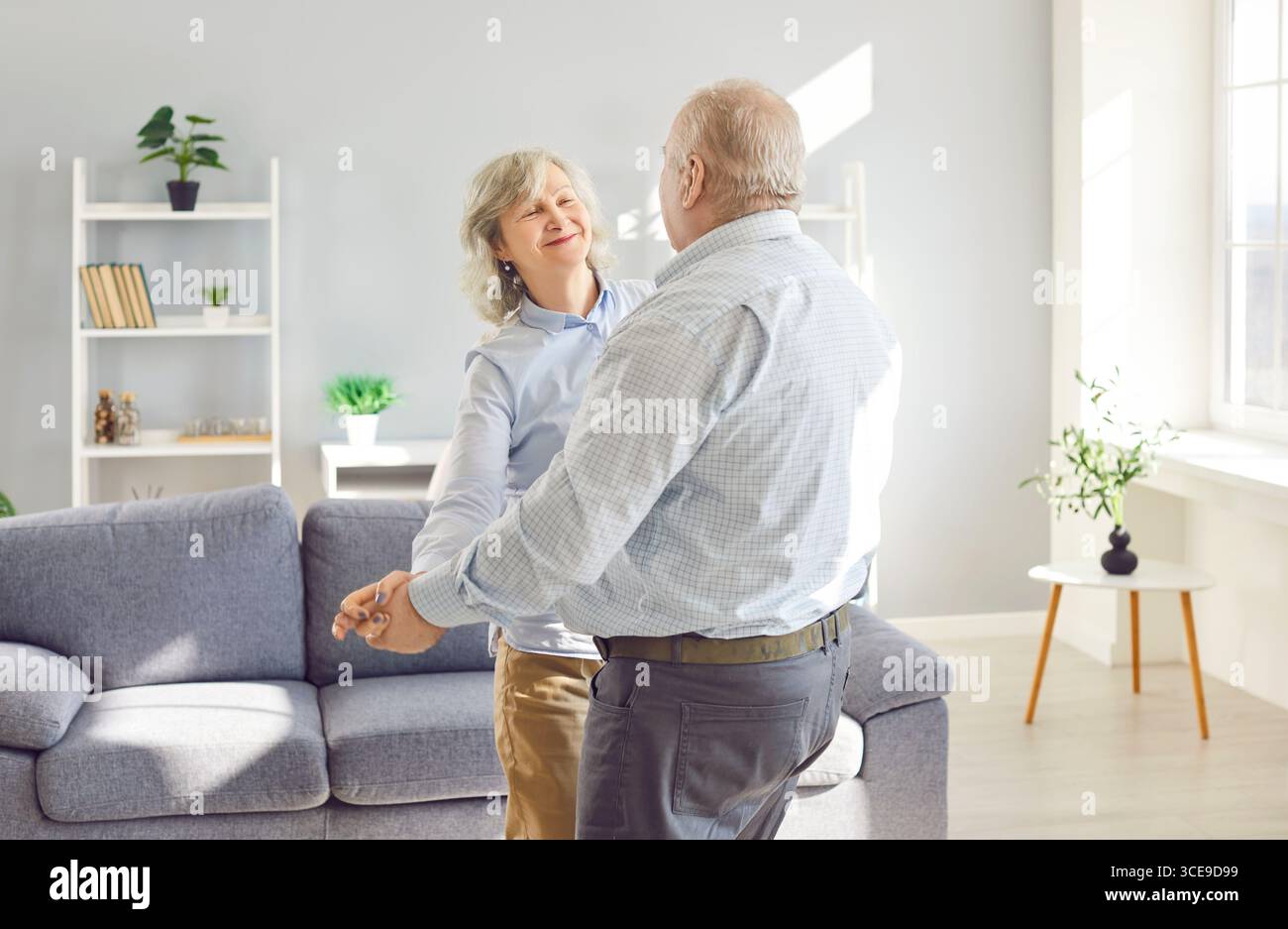 Happy Senior Couple Dancing Together At Home Stock Photo