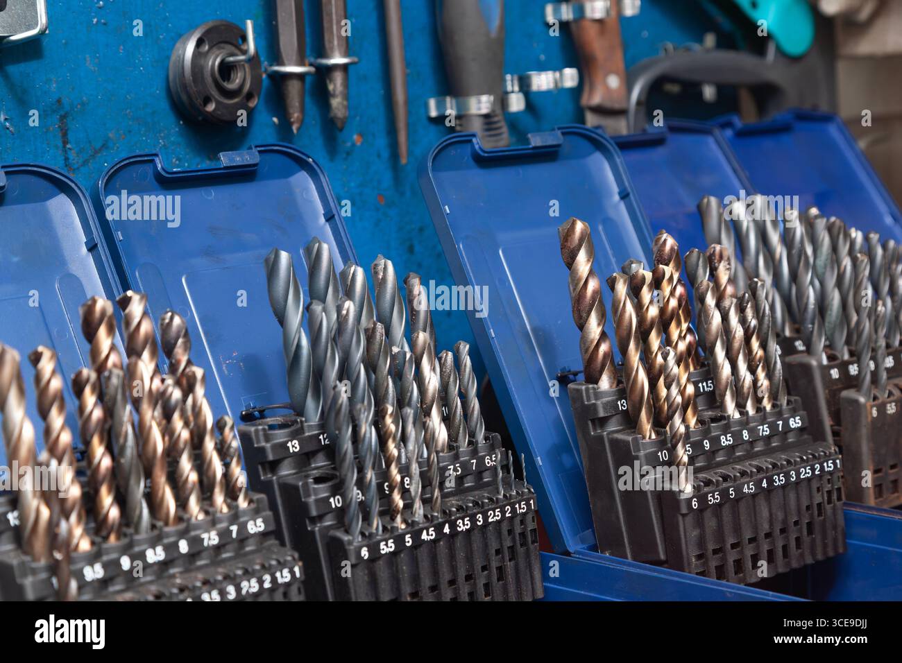 Sets of drills on a table in a workshop. Stock Photo