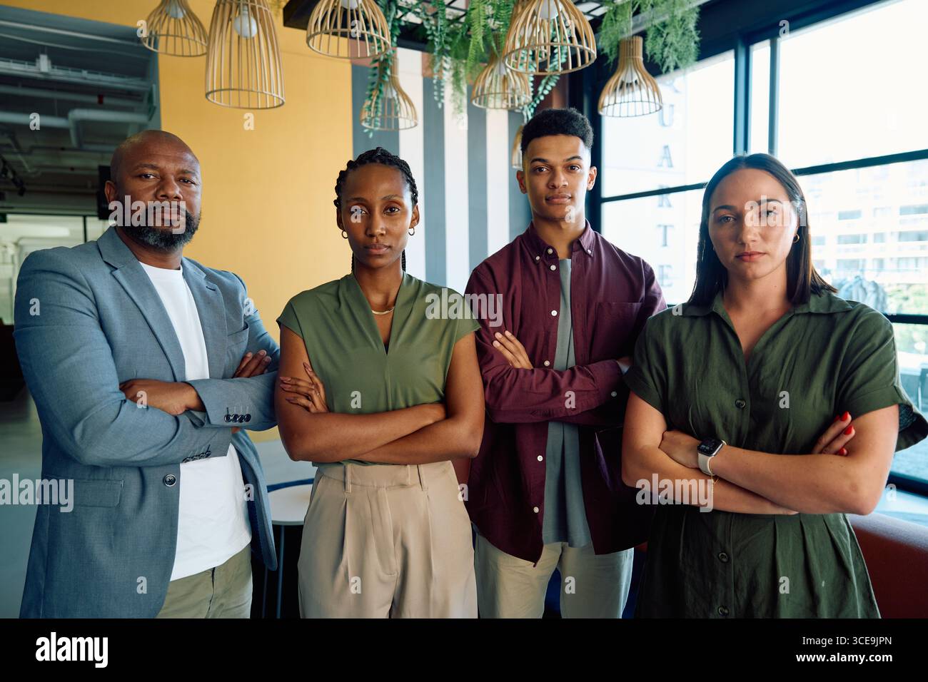 Group of serious business people standing side by side with arms ...