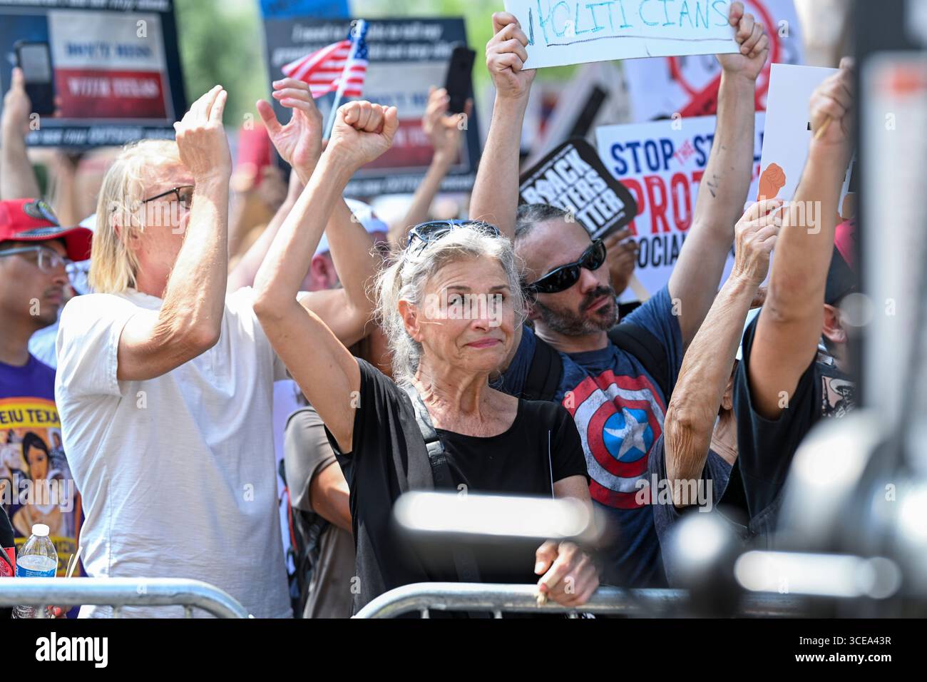 Austin, United States. 16th Aug, 2025. Austin resident KATHERINE GRIEGO holds a protest sign during a 'Fight The Trump Takeover' progressive rally at the Texas Capitol in Austin on August 16, 2025. Hundreds of Democrats and progressive Texans decried Republican redistricting efforts and Gov. Greg Abbott's handling of flood relief. Credit: Bob Daemmrich/Alamy Live News Stock Photo