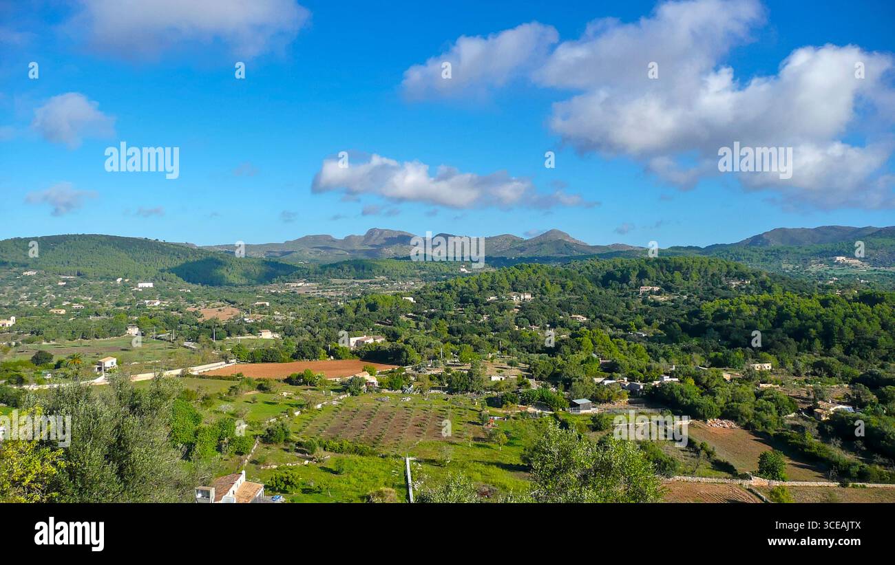 View over the rural hinterland of Mallorca from an elevated viewpoint – small villages and farmhouses under a blue sky Stock Photo