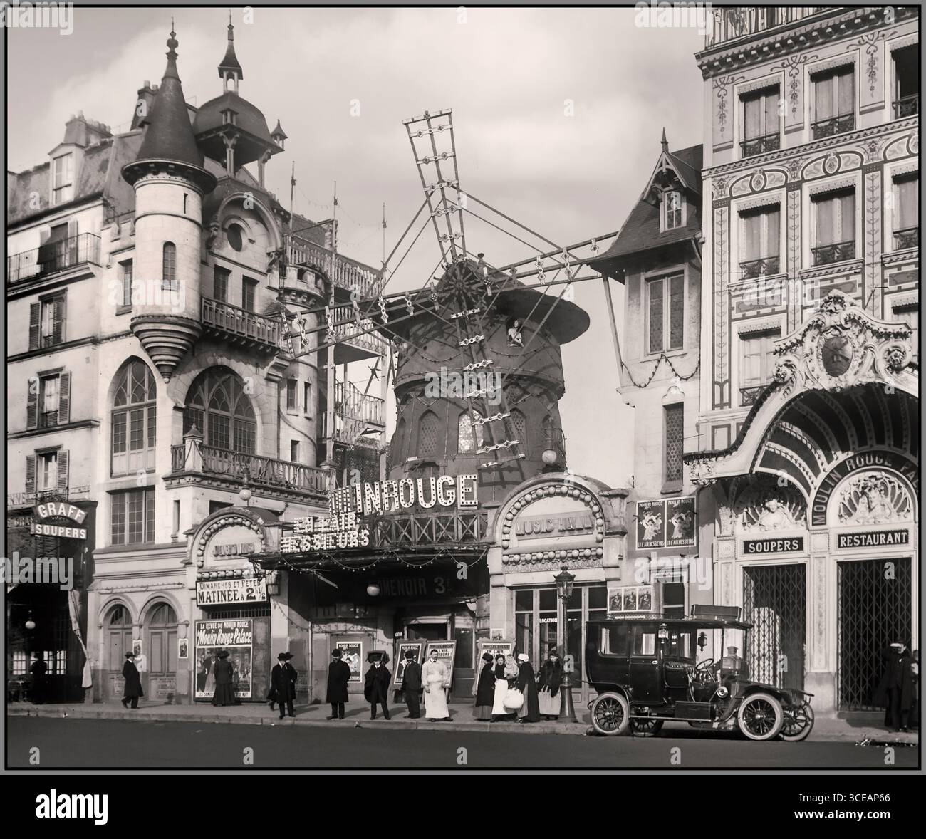 Le Moulin Rouge (Paris) France 1910 with Renault type CB town car of the era parked in the street outside Moulin Rouge Paris 82 Boulevard de Clichy Paris France Stock Photo