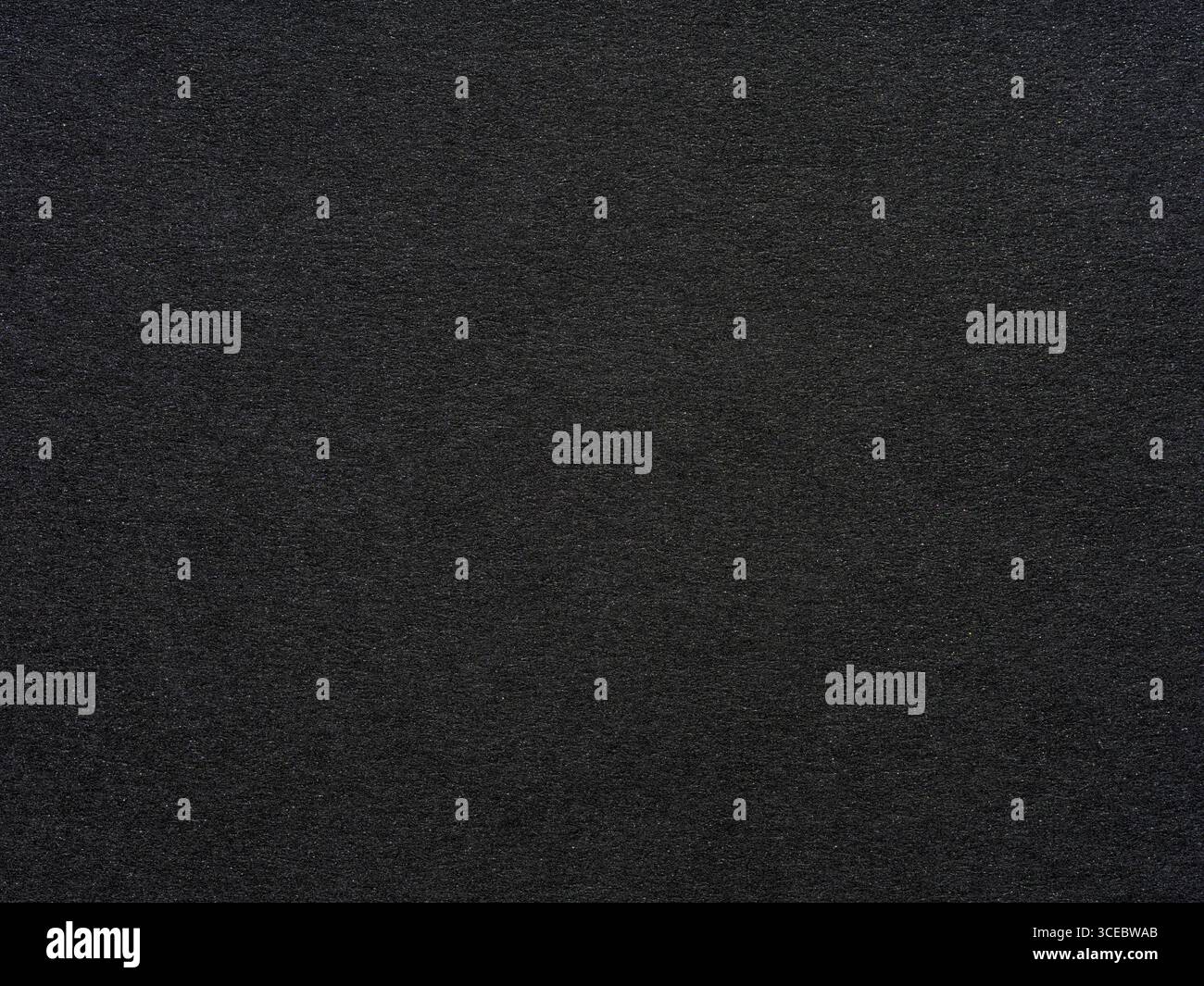 A dark tapestry of texture, the paper's surface tells a story in shades of profound gray Stock Photo