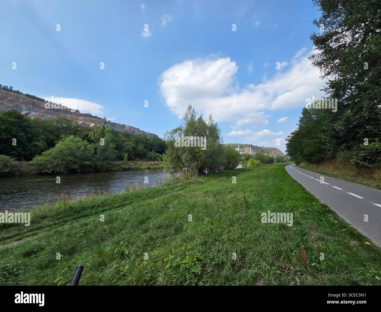 The scenic cycling path to Vrané nad Vltavou runs alongside the Vltava River in the Czech Republic on a beautiful and sunny summer day. - Smartphone Captured Stock Image