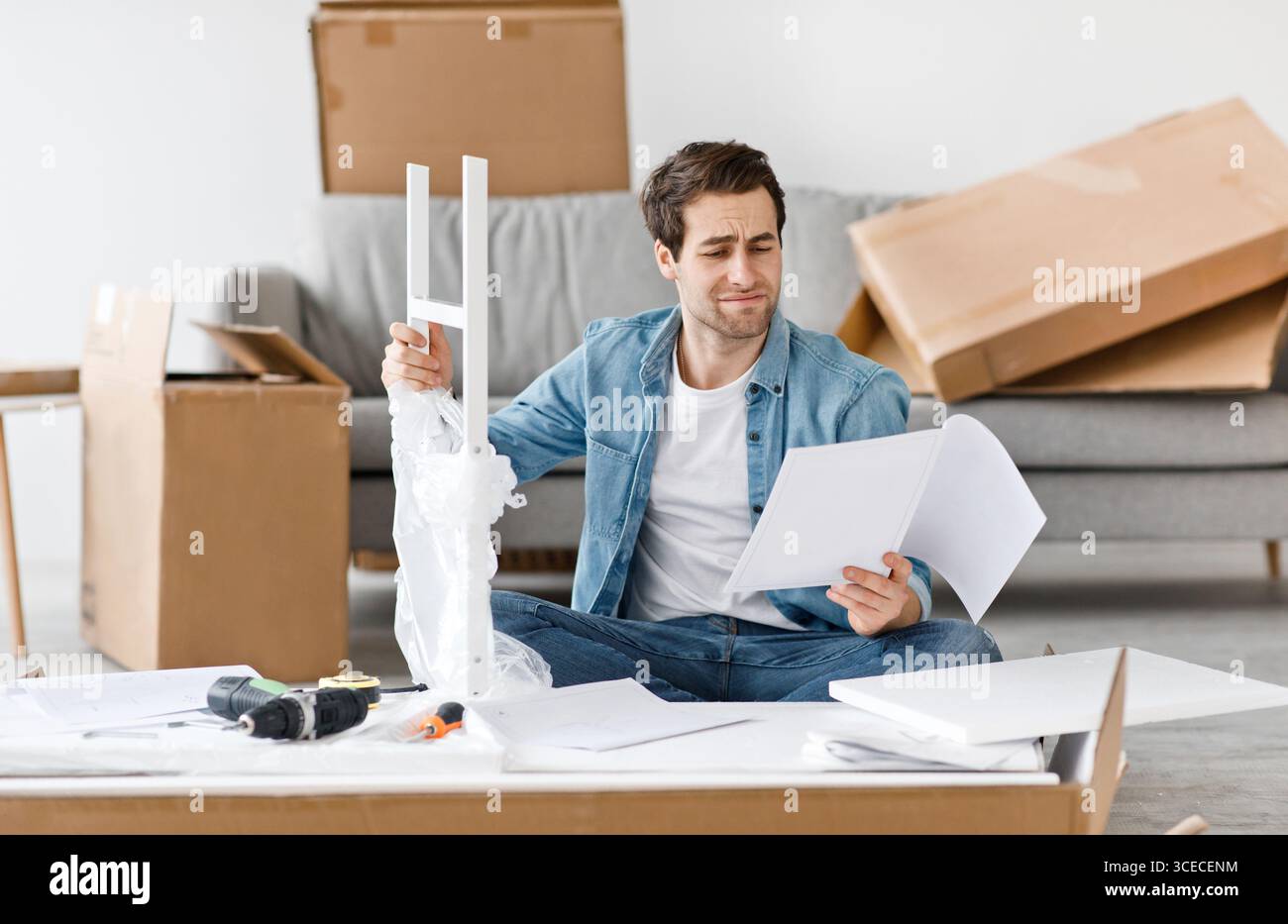 Difficulties and problems in assembling new furniture at home without master Stock Photo