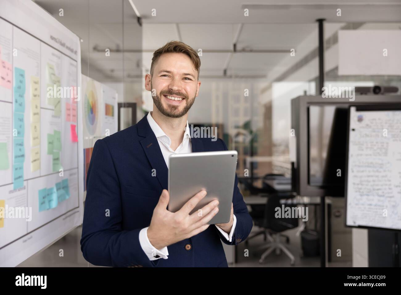 Happy successful young executive man using Internet technology Stock Photo