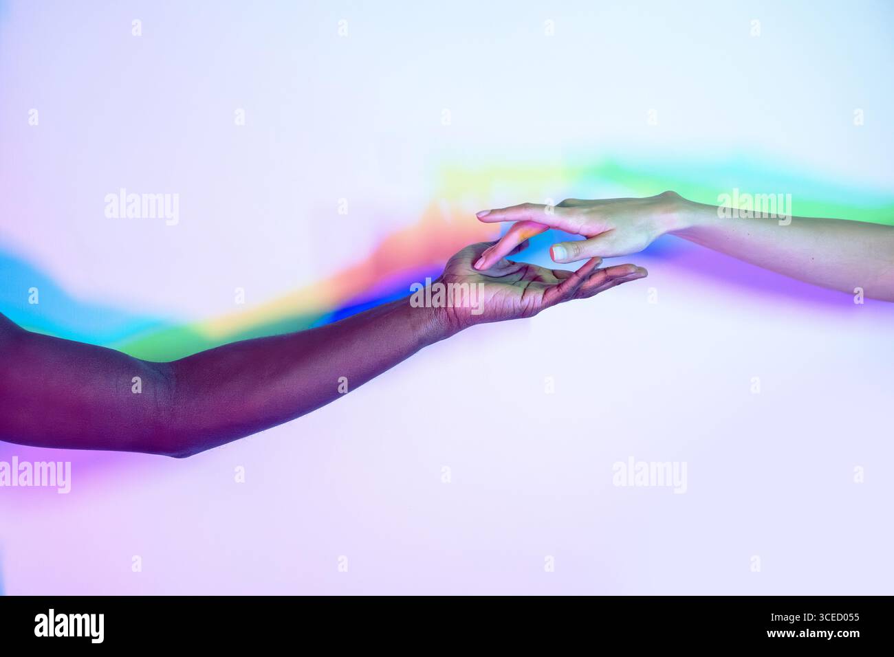 Two multiethnic hands reaching towards each other, symbolizing unity ...