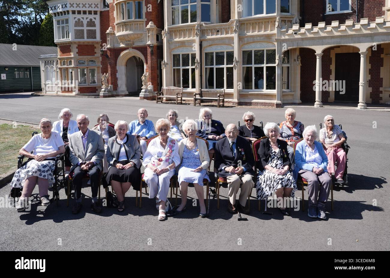 Veterans pose for a group photograph in front of Bletchley Park Mansion ...