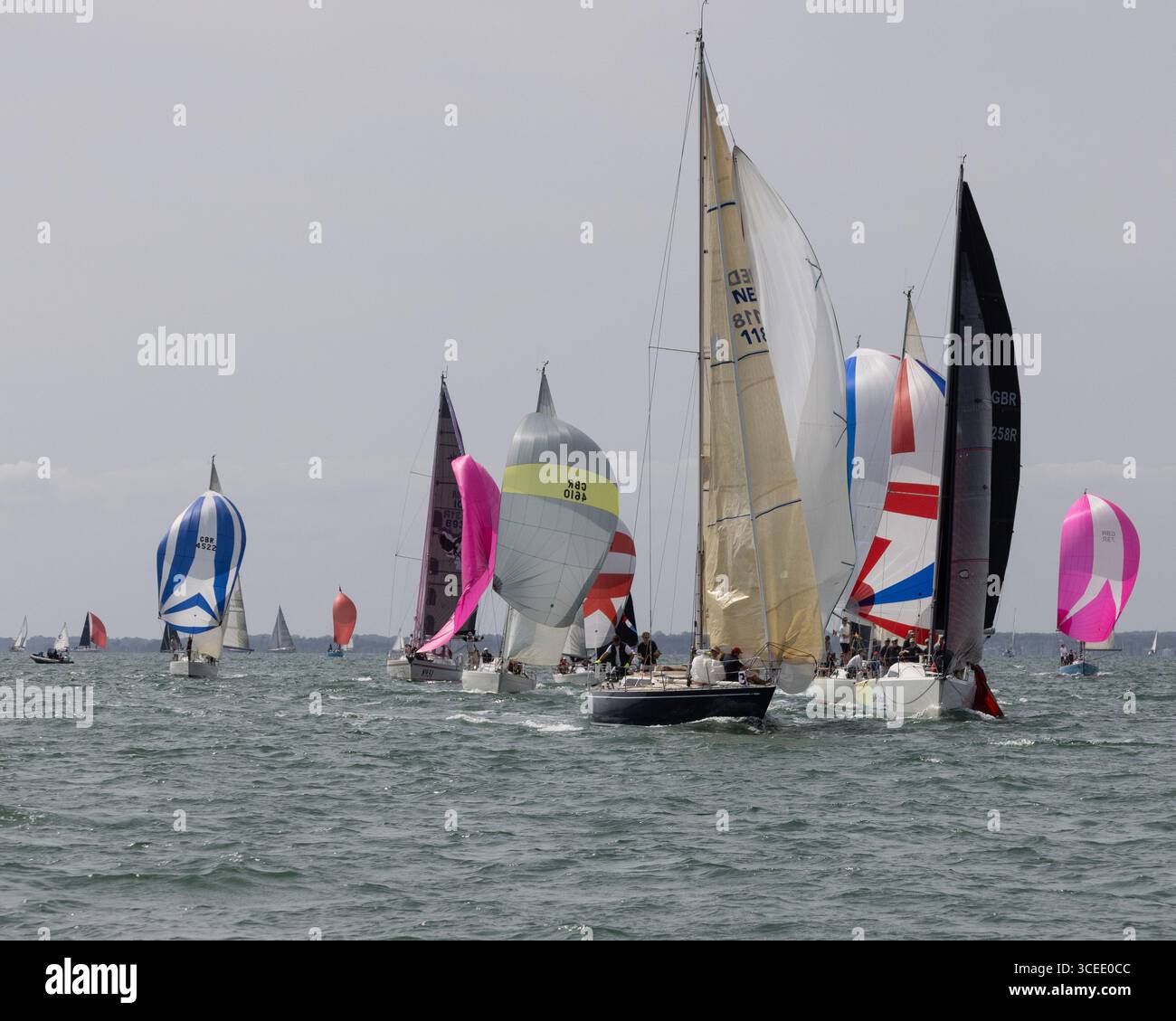 NED118 'Winsome' and  Sunfast 3600 GBR8258 'Solis Ortus' lead a group of boats under spinnaker at Cowes Week 2025 Stock Photo