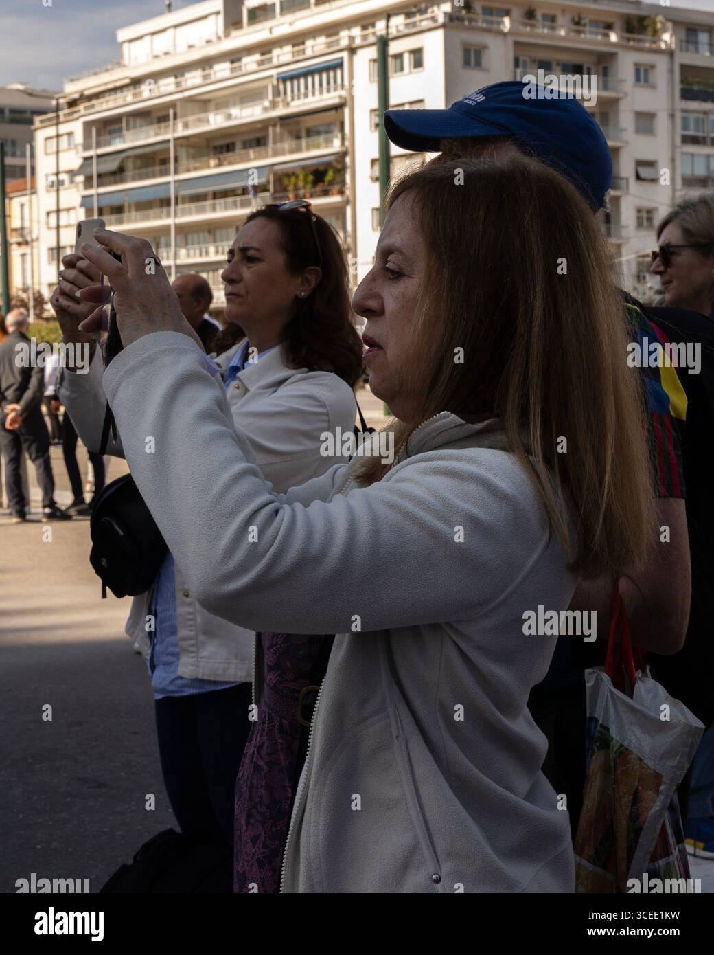 Close-up of women taking photos in the street, Athens, Greece Stock Photo