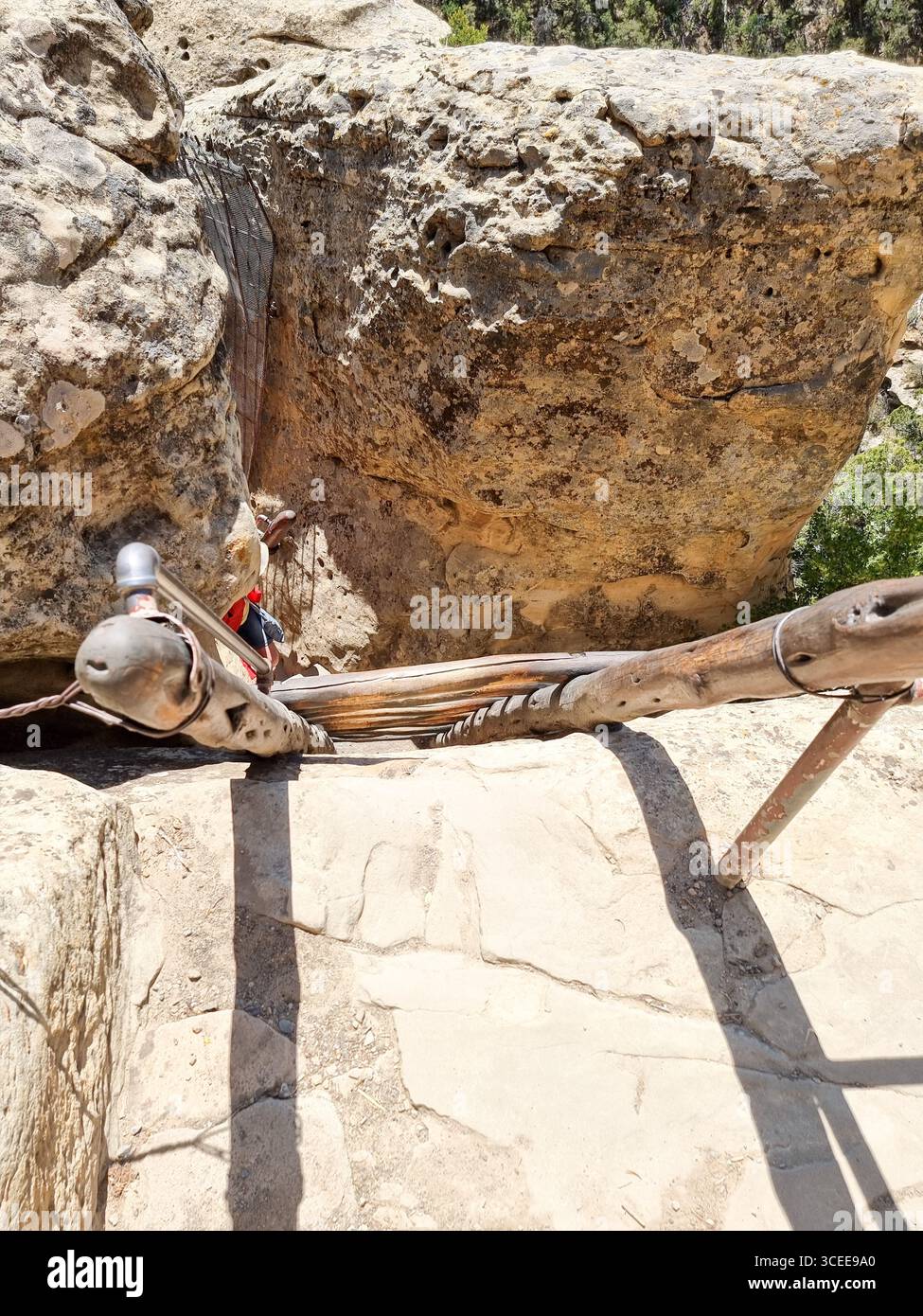 View from above on wooden stairs going down a rock cliff in Mesa Verde National Park Colorado United States on a tour to one of the ancient dwellings - Smartphone Captured Stock Image