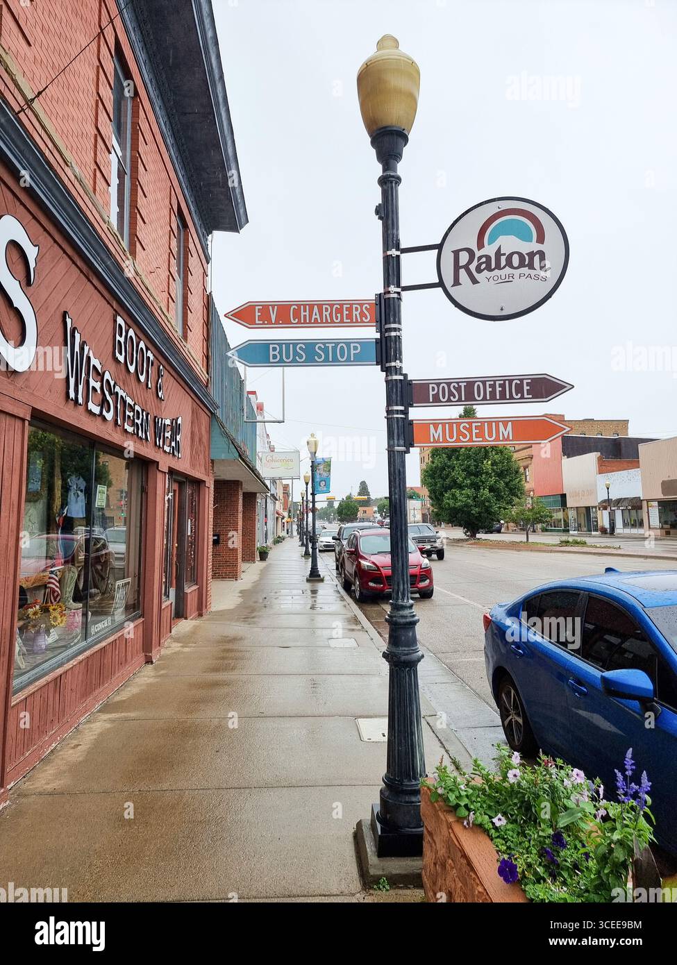Historic street lantern with Raton city branding and wayfinding signage; signs to post office, museum, etc. on main street in Raton New Mexico. U.S.A. - Smartphone Captured Stock Image