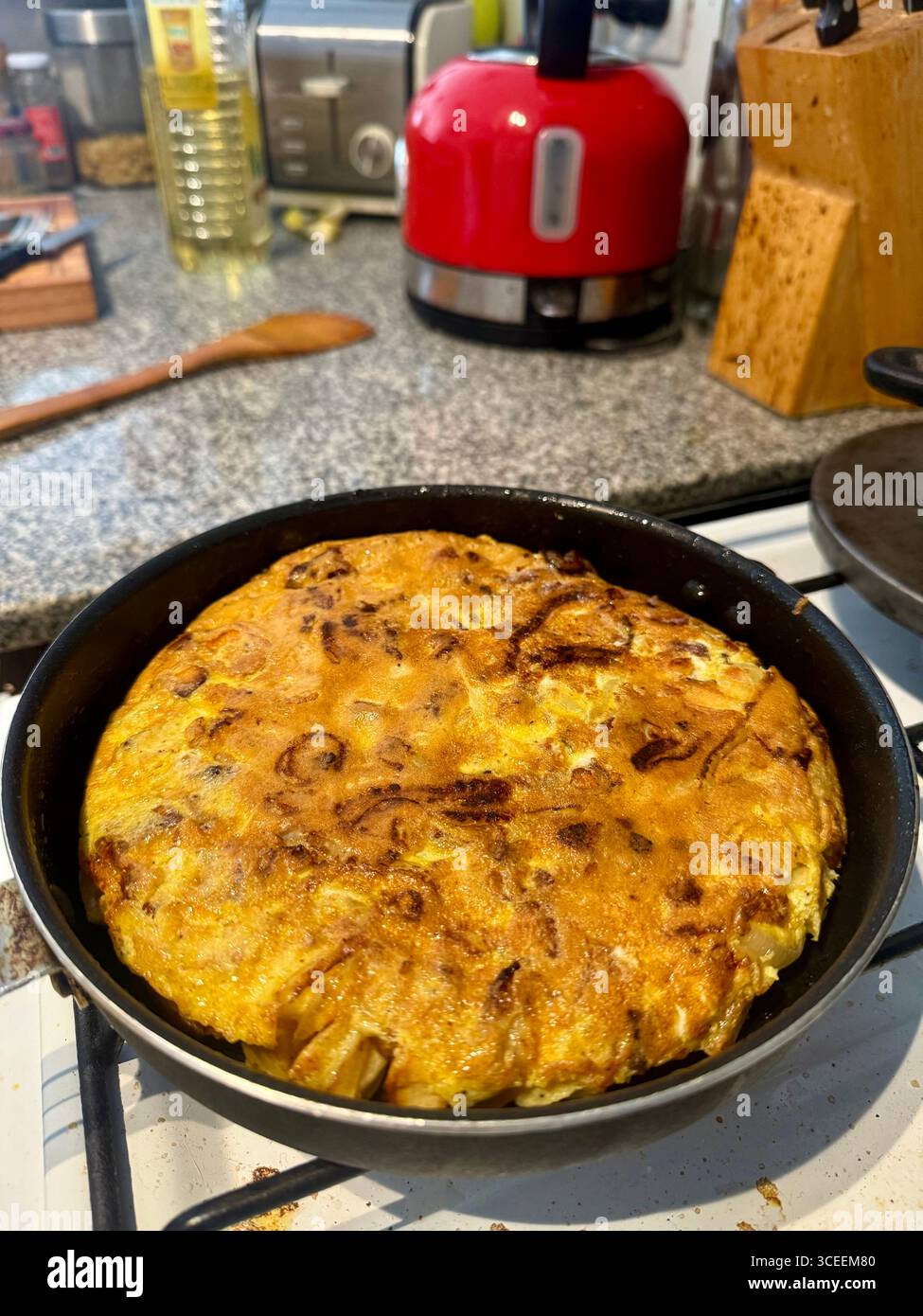 Homemade Spanish omelette cooking in a frying pan - Smartphone Captured Stock Image Homemade Spanish omelette cooking in a frying pan - Smartphone Captured Stock Image