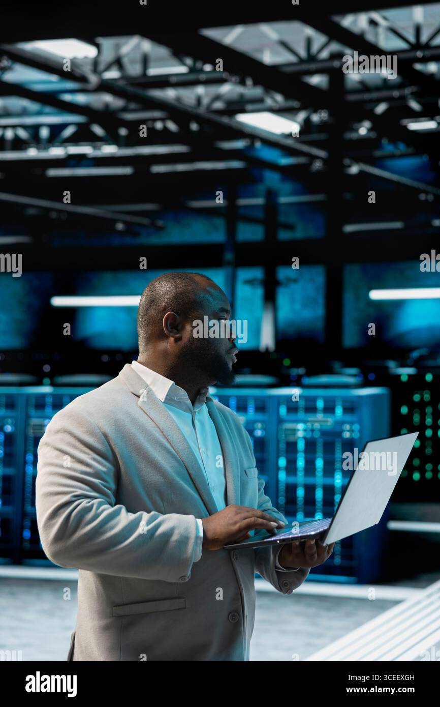 Data center admin running system diagnostic tests and error checking utilities, automating anomaly detection. IT expert monitoring server performance, looking for network issues affecting rigs Stock Photo