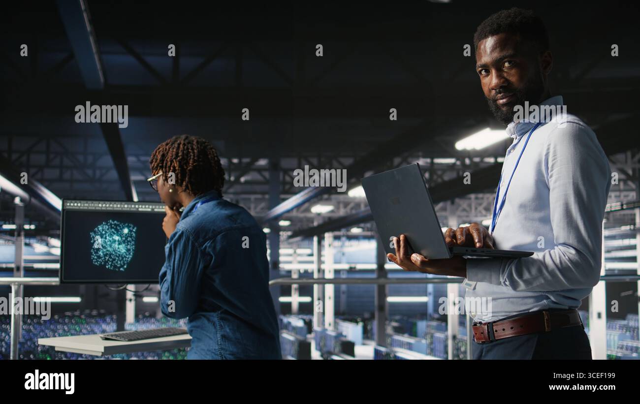 Smiling data center engineering team on industrial platform collaborating on neural network software tasks. Jolly server hub colleagues working together, visualizing large language model architecture Stock Photo